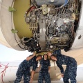  Example of a jet engine equipped with a Woodward fuel control (large horizontal can like part with a red sticker to the right center of photo).