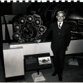 Frank Whittle with his first jet engine on display in a museum.