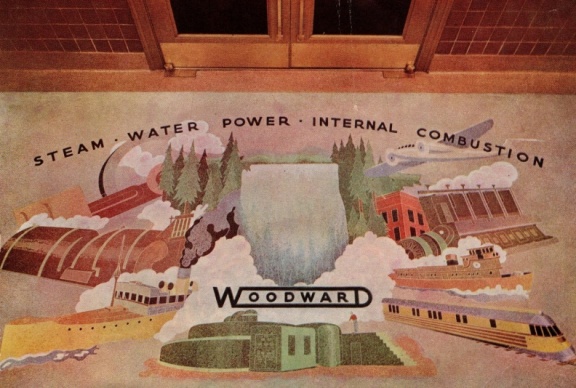 A Woodward history painting on the floor in the factory lobby.