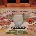 A Woodward history painting on the floor in the factory lobby.