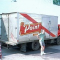 A SPB delivery truck next to the Stevens Point Brewery bottle house in 1973.