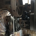 View of water wheel turbine on left and the governor in the back ground.