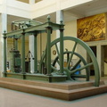 A vintage steam engine with a large flyball governor for control.