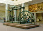 A vintage steam engine with a large flyball governor for control.