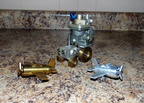 An experimental Woodward gas turbine governor with a Woodward worker's custom made tractor, brass airplane and an aluminium airplane.