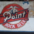 A vintage beer sign used for shelving.