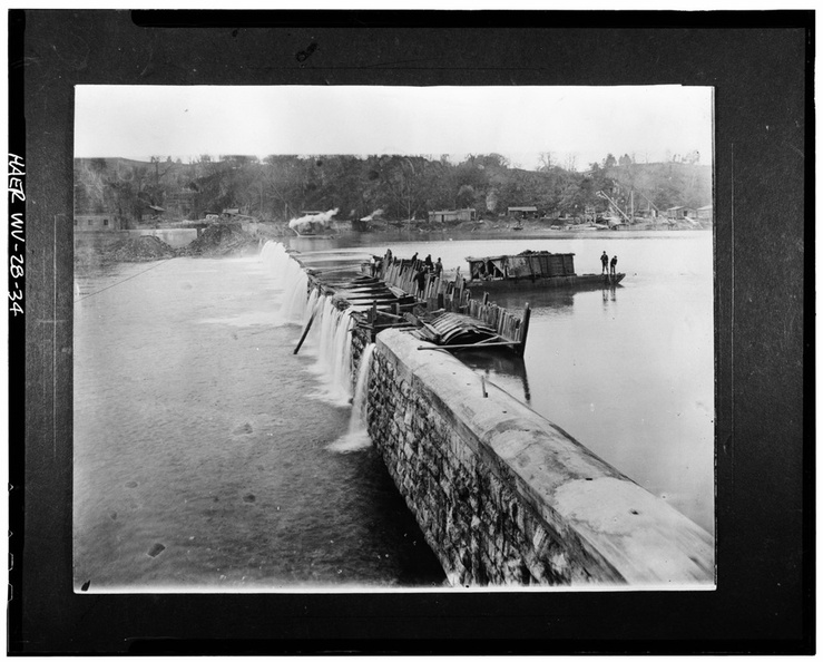 VIEW_OF_COFFERDAM_USED_IN_DAM_CAPPING_OPERATIONS._NOTE_BARGE_AT_RIGHT_DUMPING_FILL_DIRT_TO_INCREASE_WATER_TIGHTNESS_OF_COFFER_DAM,_c._1918._-_Dam_No._5_Hydroelectric_Plant,_On_HAER_WVA,2-HEDVI.V,1-34.tif.jpg