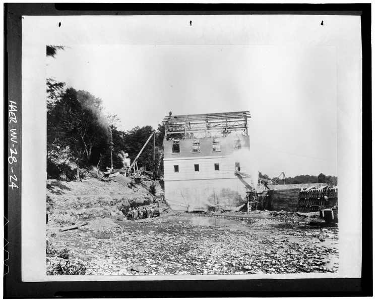 EAST ELEVATION. NOTE MANUAL LABOR USED IN EXCAVATING TAILRACE ON LEFT, AND FORM WORK FOR CONCRETE TAILRACE WALL ON RIGHT, July 28, 1918. - Dam No. 5 Hydroelectric Plant, On HAER WVA,2-HEDVI.V,1-24.tif