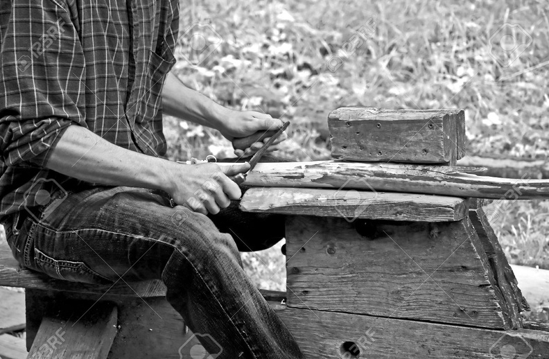 16859750-this-man-is-using-a-pioneer-draw-knife-on-wood-used-to-remove-bark-from-timber-in-this-vintage-black.jpg