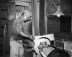 Joe Hess using a circling machine to create a barrel head at the Hess Cooperage, circa 1952.