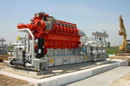 A diesel engine connected to a gas compressor.