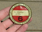 A World War ll era employee name badge.