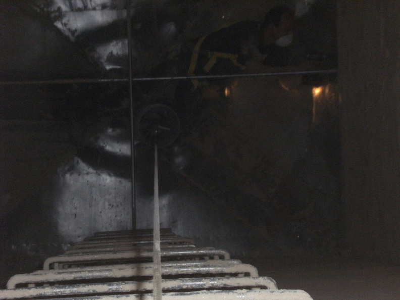 Looking in the brewery's malt bin  three stores down to the bottom of the wooden malt bin.