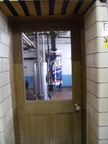 Looking out from the brewhouse into the engine room working at the Stevens Point Brewery.