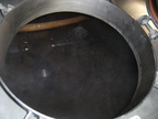 Cleaning out the spent grain while boiling the wort in the other brew kettle.