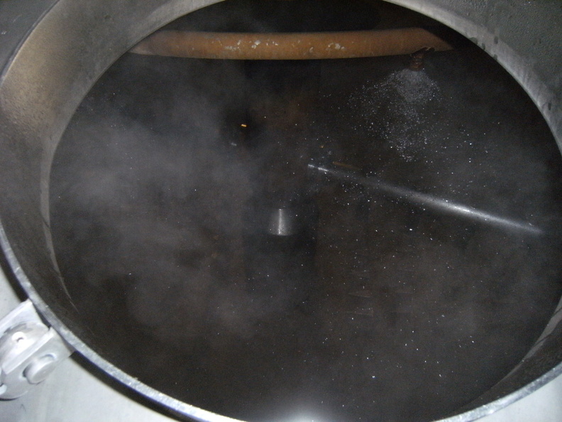 Sparging the mash in the lauter-tun kettle, running off the wort into the brew kettle.