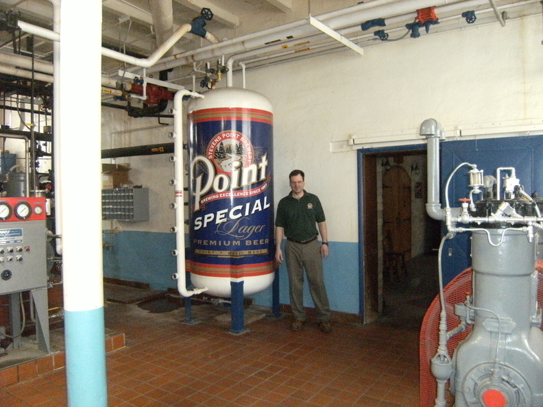 Brewer Brad next to the ammonia pressure tank for the brewer's cooling system.