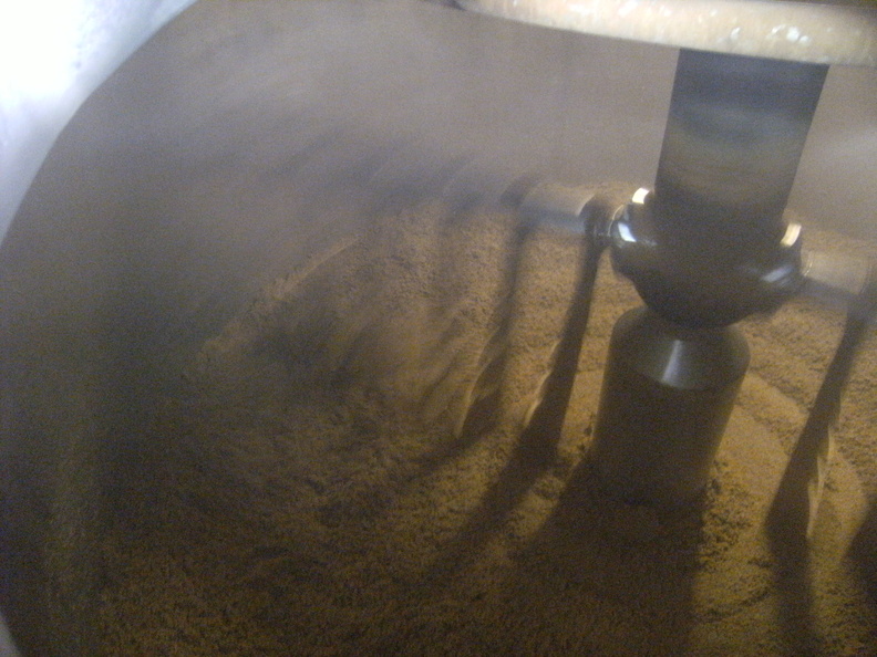 Emptying the spent grain mash in the lauter-tun after running off the wort in the malt.