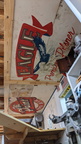 Old beer signs made into brewery garage shelving upcycled into ceiling art in the man cave.