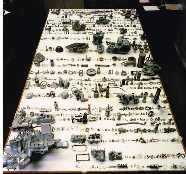 A jet engine fuel control governor unit disassembled and all the components on display..jpg