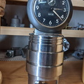 A Baby Ben whined up clock on a hydraulic pump piston.