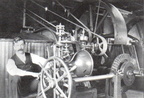 Elmer Woodward adjusting his patented compensating type water wheel governor in a Canadian Paper Mill.