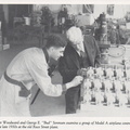 Elmer and George looking over propeller engine governors ready for shipment.