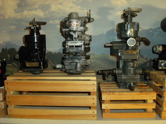 Two Woodward aircraft engine governors and a Hamilton Standard governor in the middle(made by Woodward).
