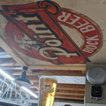 Upcylinging old beer signs made into brewery garage shelving, now used as ceiling art.