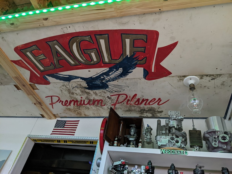 Upcycling old signs to brewery garage shelving to ceiling art.