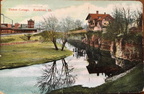 A postcard of the Tinker Swiss Cottage showing the Railroad Depot across Kent Creek.