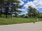 The frontage road connecting the Woodward driveway to the left.