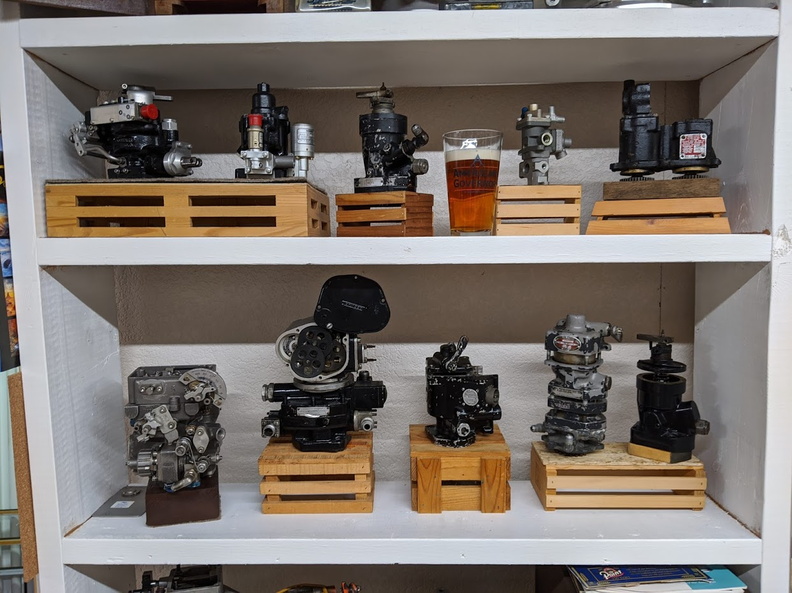 Aircraft engine controls from left to right on lower shelve. A Bendix gas turbine fuel control, a Hamilton Standard constant sped control with electric head, a Curtiss-Wright electric proportional governor, a Hamilton Standard governor and a Woodward CSSA governor. 20200528161543-ea2b26f1.jpg