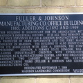 A history plaque on the Fuller & Johnson Manufacturing Company's Office Building in Madison, Wisconsin.