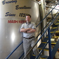 Brewer Brad in the office behind the 6000 gallon (200 barrel) MDV Mash Kettel in the Stevens Point Brewery.