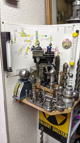 An AiResearch small gas turbine fuel control surrounded by scrap gas turbine governor components and tooling.  2..jpg
