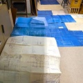 The blueprints laid out on the floor.
