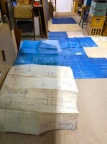 The blueprints laid out on the floor.