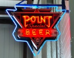 A vintage Point Special Beer neon sign in the bottle house.