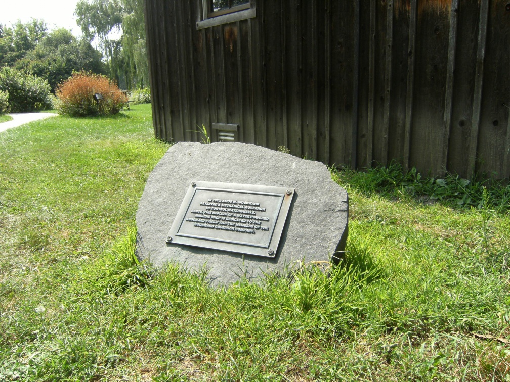 The Woodward Company history plaque in front of the mill house.