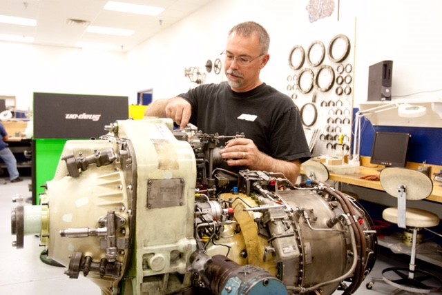 Working on a Honeywell TPE 331 series gas turbine engine.