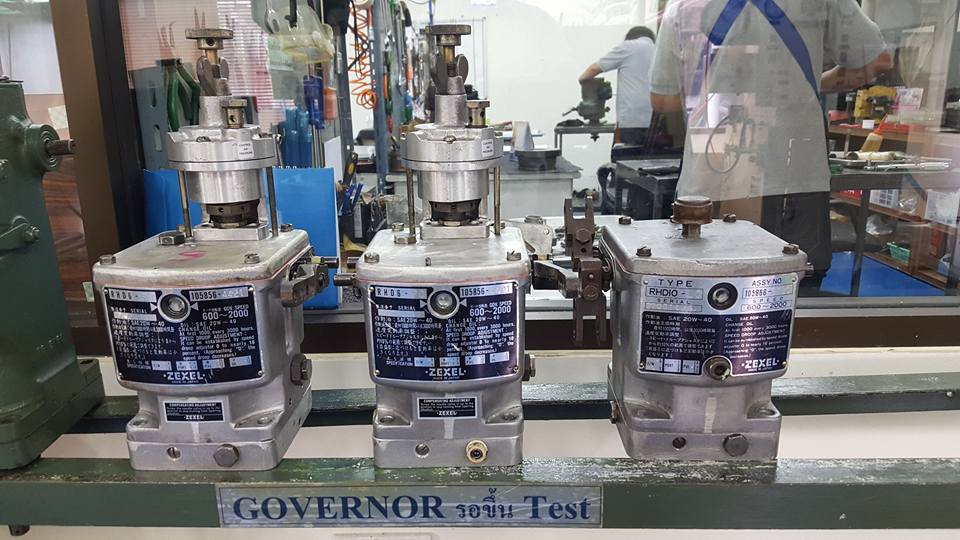 Three Zexel small engine governors similar to a Woodward SG governor.