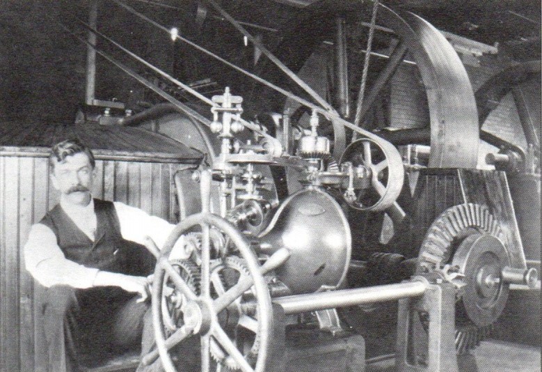 Elmer Woodward installing his patented compensating type turbine water wheel governor.